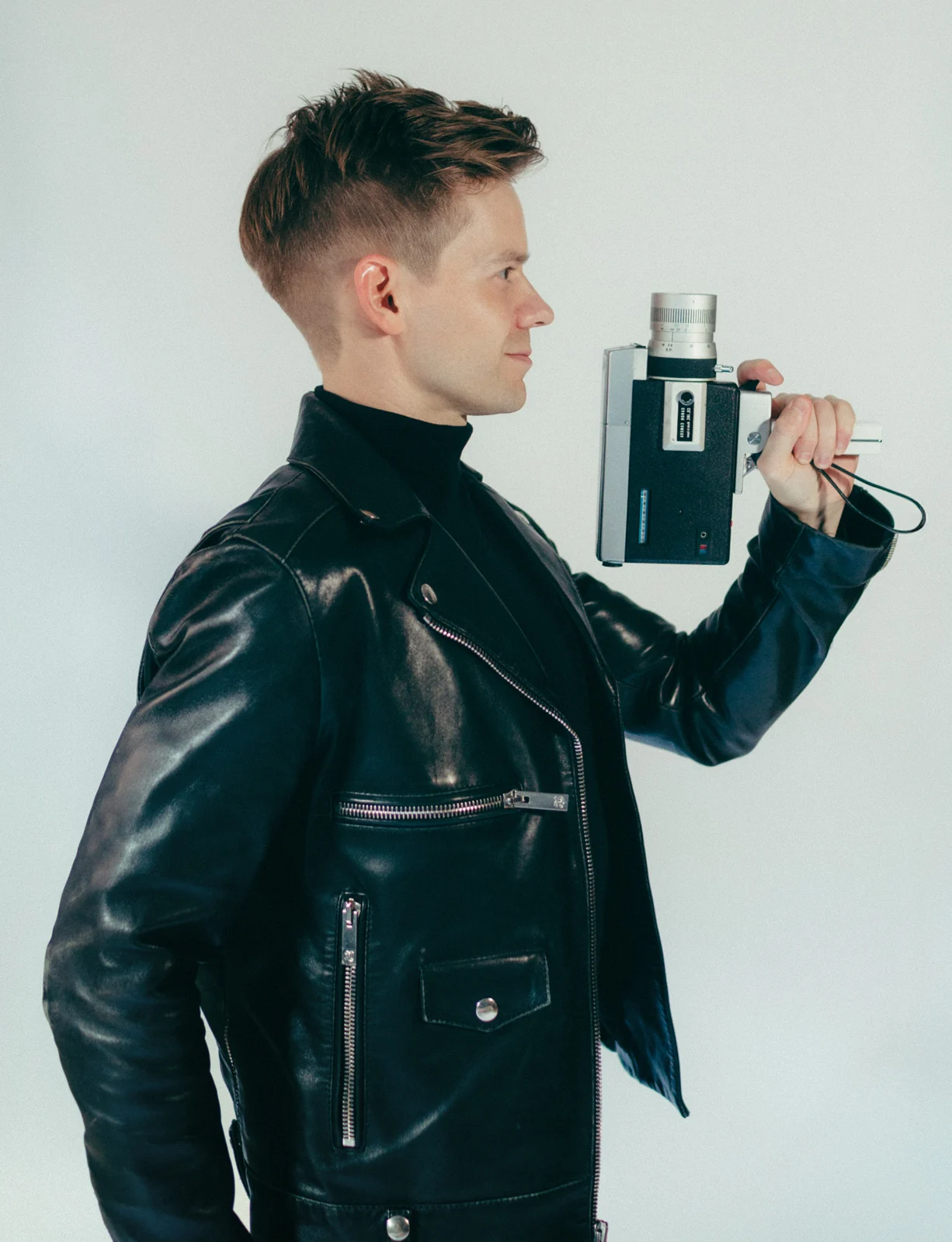 Andrew Keenan-Bolger holding a vintage film camera