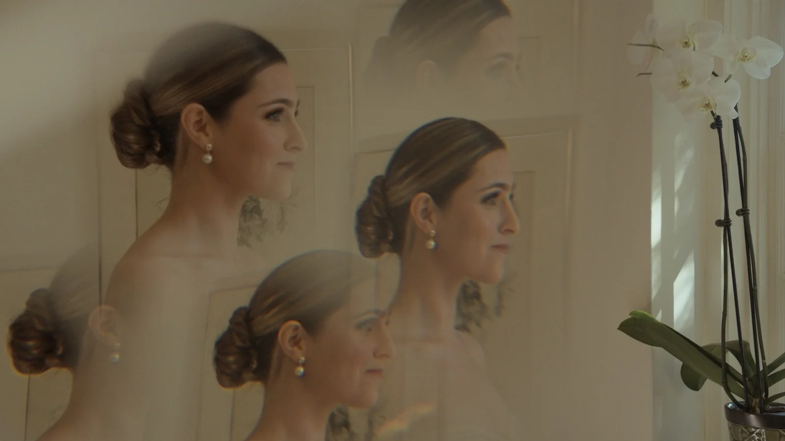 Maddie in her wedding dress reflected in a mirror