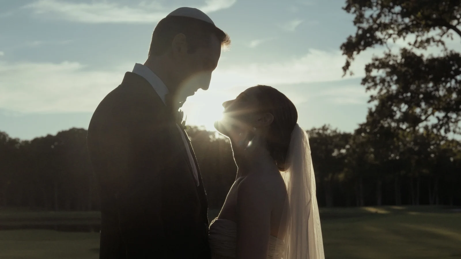 Maddie and Cole together outdoors at sunset during their wedding weekend in Michigan